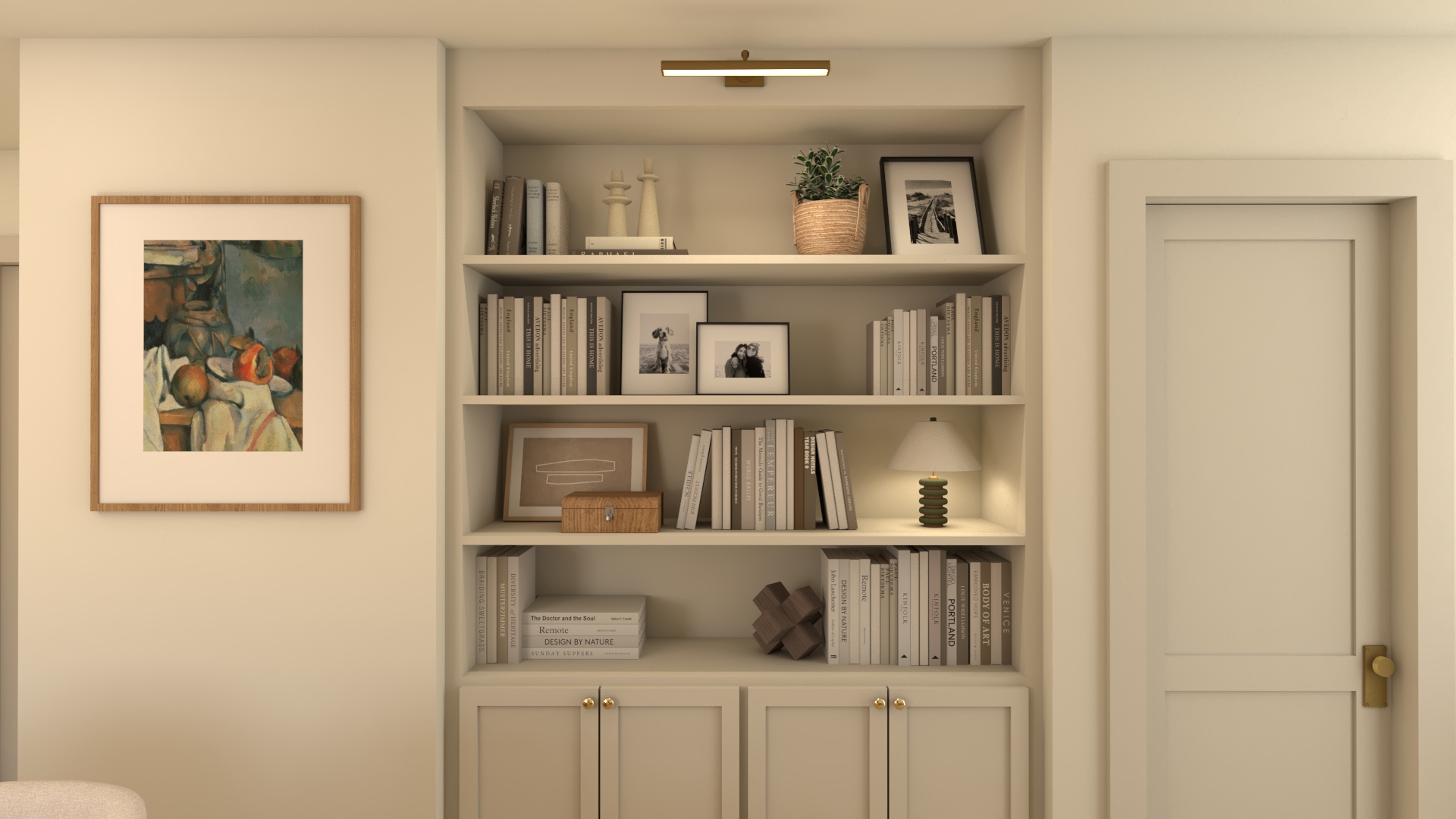 A styled built-in bookshelf with brass lighting, books, and cabinetry below